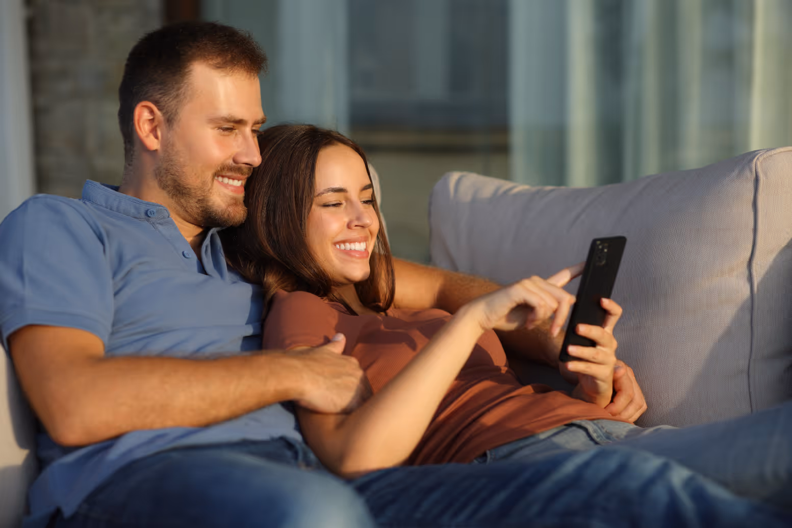 Couple sitting on sofa stock image