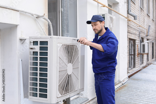 South Tampa HVAC technician servicing an outdoor air conditioning unit, illustrating Local Service Ads lead generation