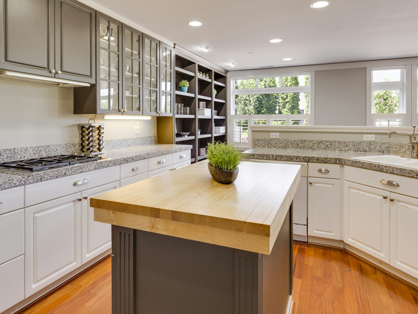 Bright kitchen with granite countertops and a butcher-block island