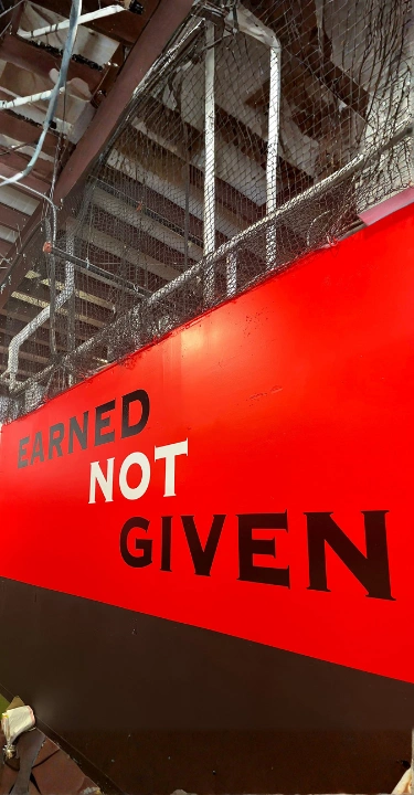 "Earned Not Given" motivational wall mural at PSP3