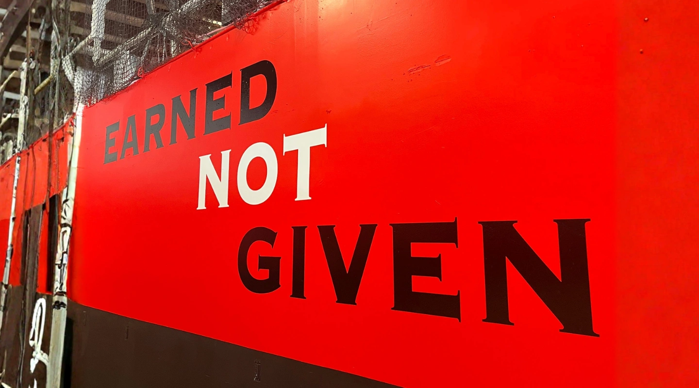 "Earned Not Given" motivational wall mural at PSP3