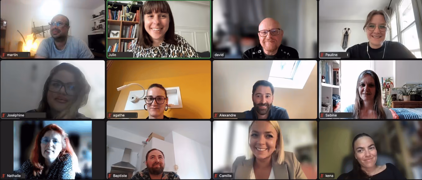 Groupe de personnes souriantes lors d'une réunion vidéo en ligne avec noms affichés sous chaque fenêtre.
