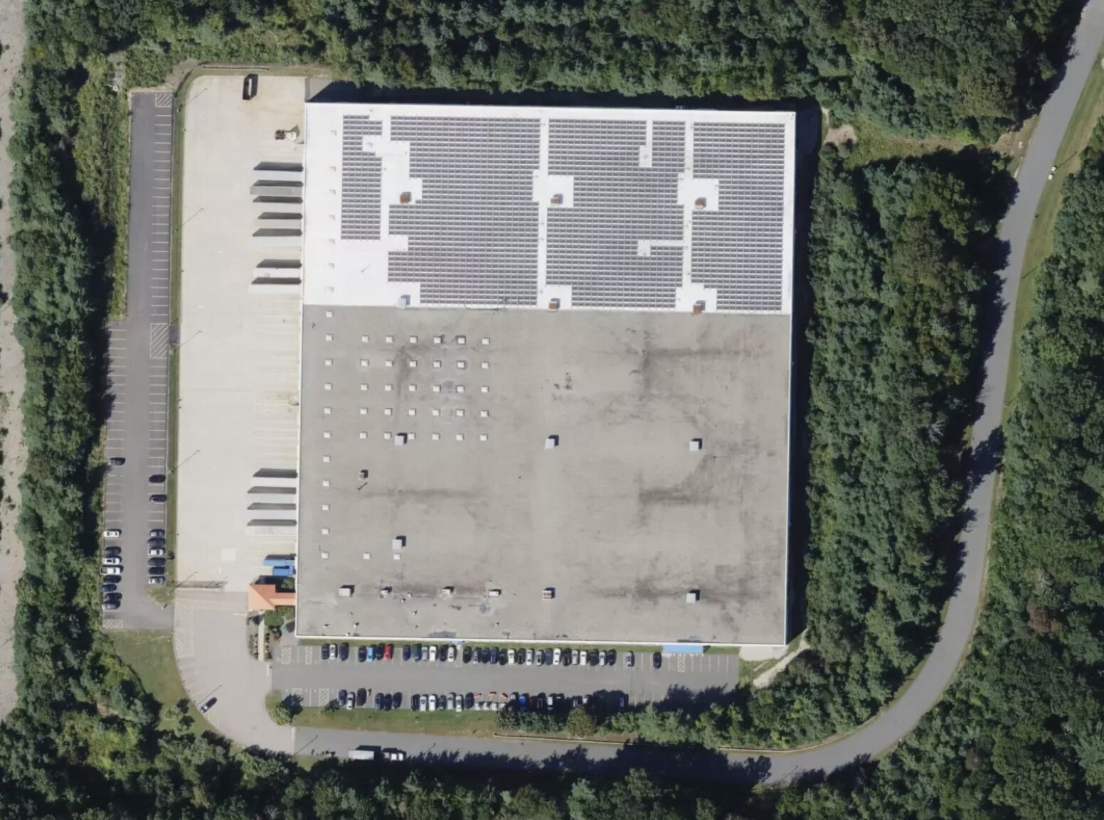 Aerial view of 200 Commerce Way with rooftop solar array