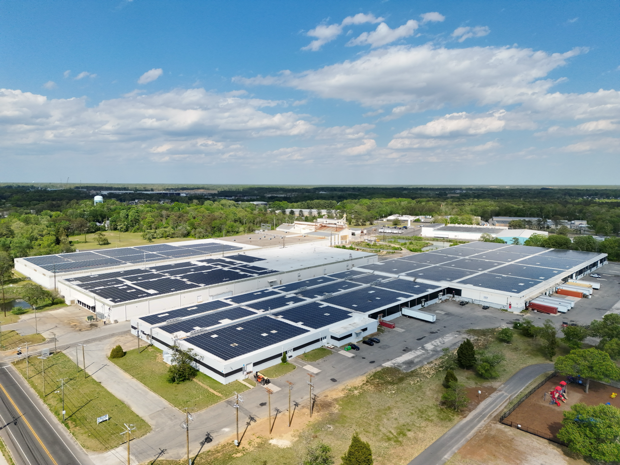 Aerial view of commercial rooftops with solar arrays