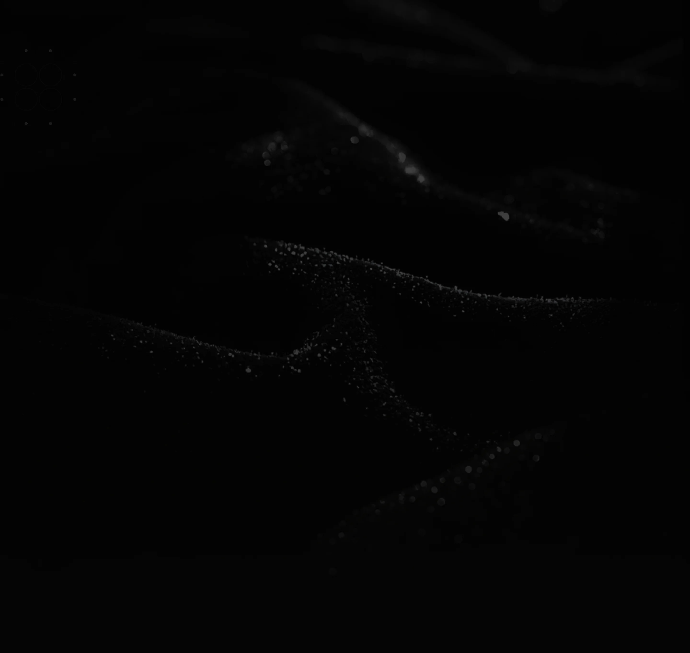 Dark fabric folds with small droplets reflecting light on its surface.