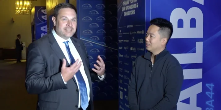 Nelson Lee speaks with Chad Druvenga of NAILBA during an industry conference interview.