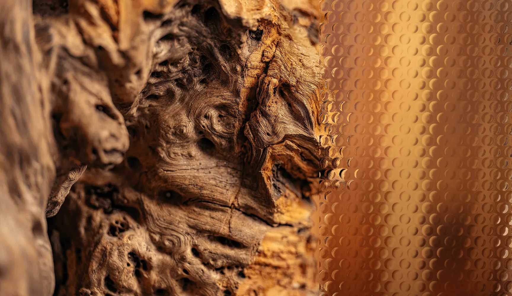 Close-up of textured, weathered wood on the left and amber-colored patterned glass on the right.