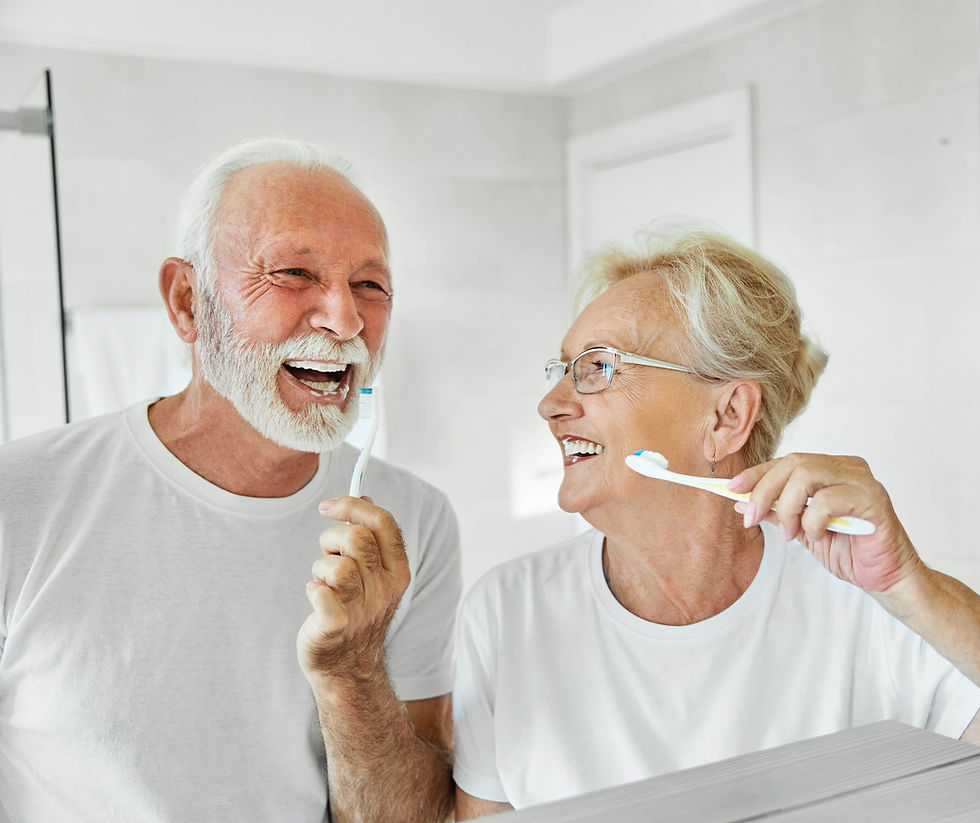 smiling elderly couple brushing their teeth together show the importance of prioritizing dental care as a senior adult