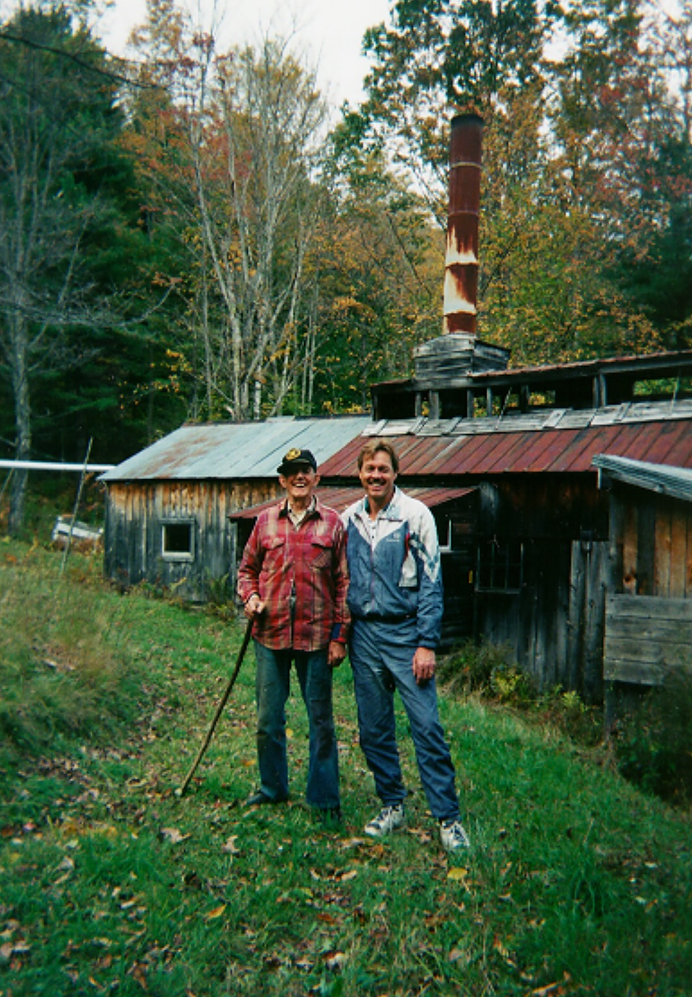 Uncle Royal and Dr. Cutts standing together in front of a traditional Vermont sugar shack