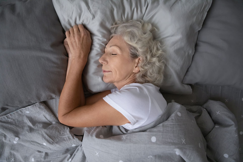 senior woman enjoying a healthy, restful night's sleep as a part of good self-care habits