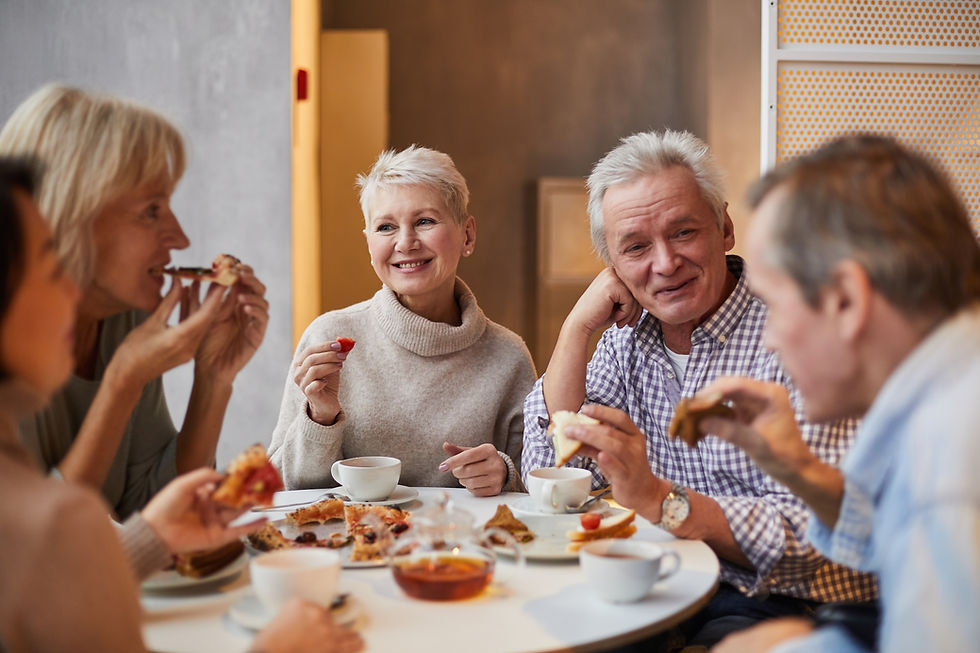 senior adults, as shown here eating a meal together, may be at greater risk of dental food impaction and should visit the dentist regularly for exams and treatment
