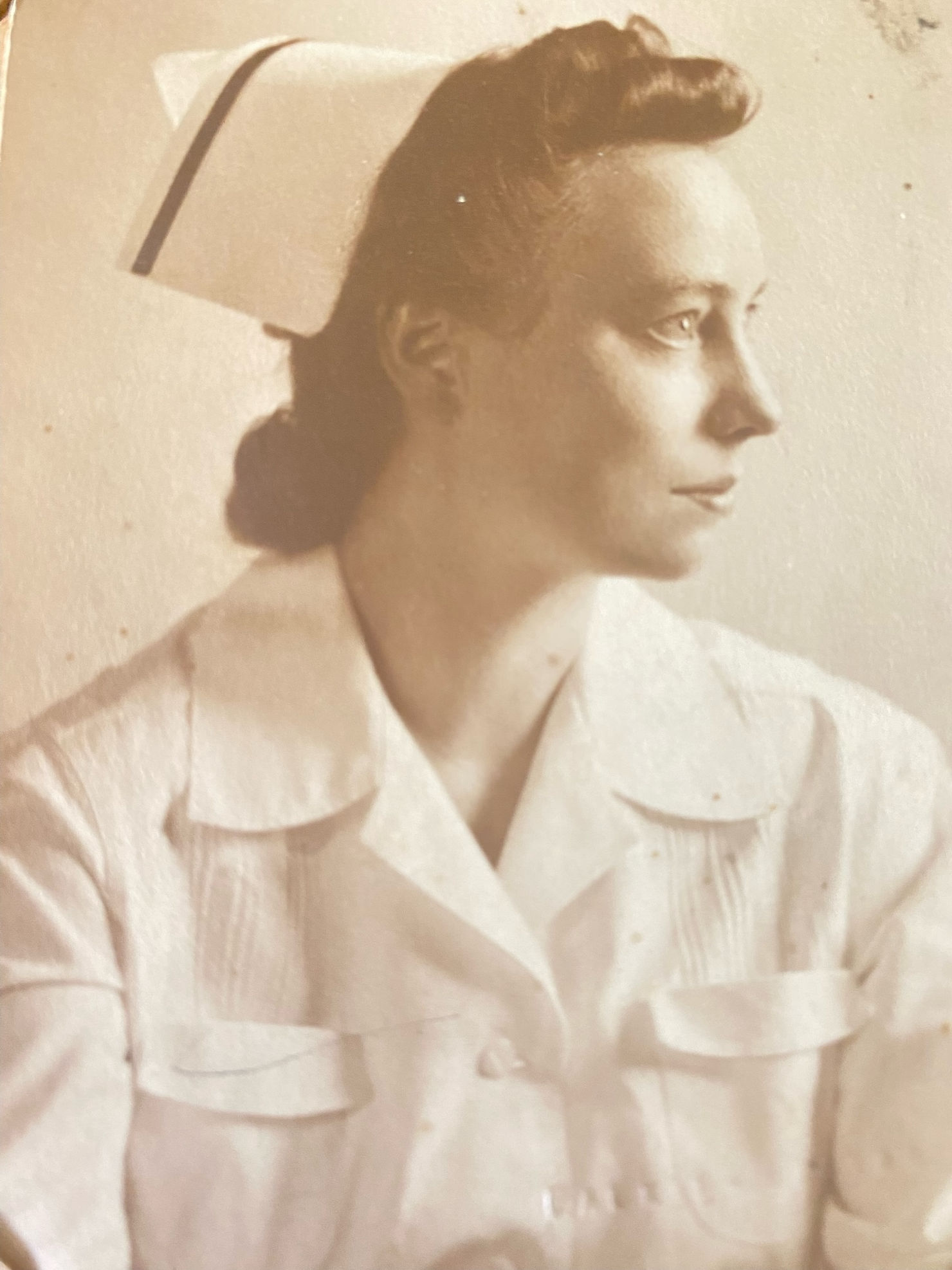 Sepia style photo of young nurse in 1940s who successfully raised her four children as a single mother, the youngest of whom became a top dentist in Temecula, Dr. Dave Cutts
