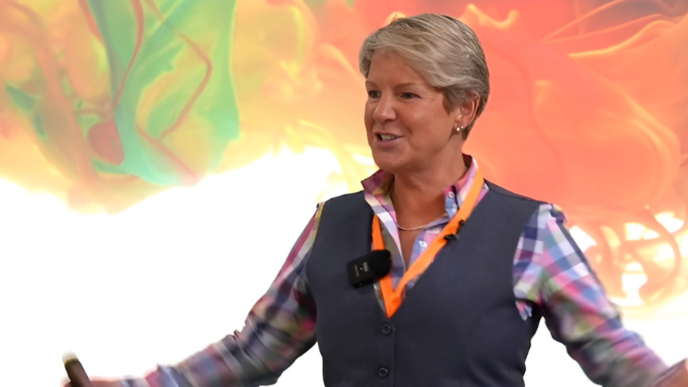 Jackie Handy leadership and culture keynote speaker smiling on stage during a live event