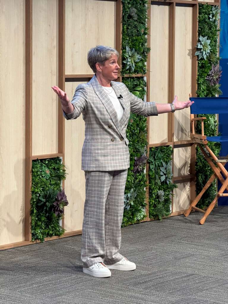 Jackie Handy keynote speaker presenting on stage at a leadership and culture conference