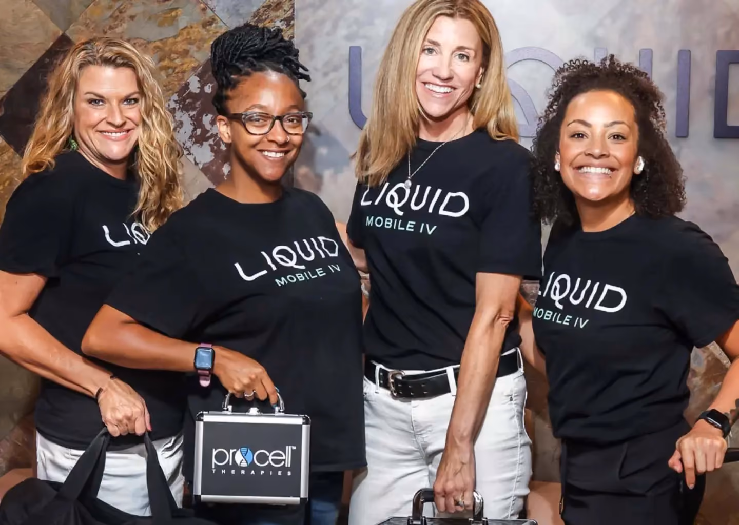 Liquid Mobile IV team members posing with mobile healthcare equipment.