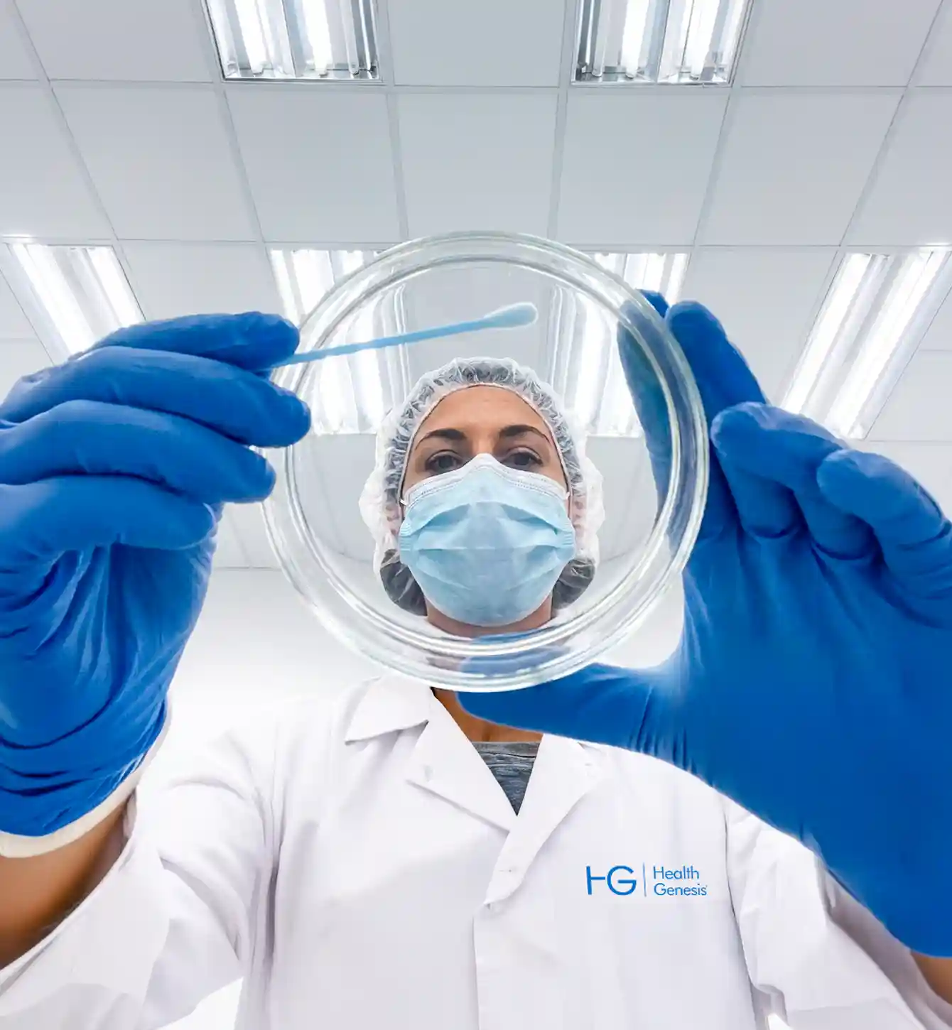 Technician in a hairnet and face mask working in the laboratory