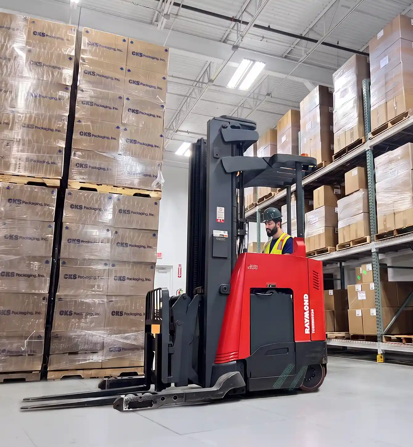 Forklift operator moving pallets in the warehouse