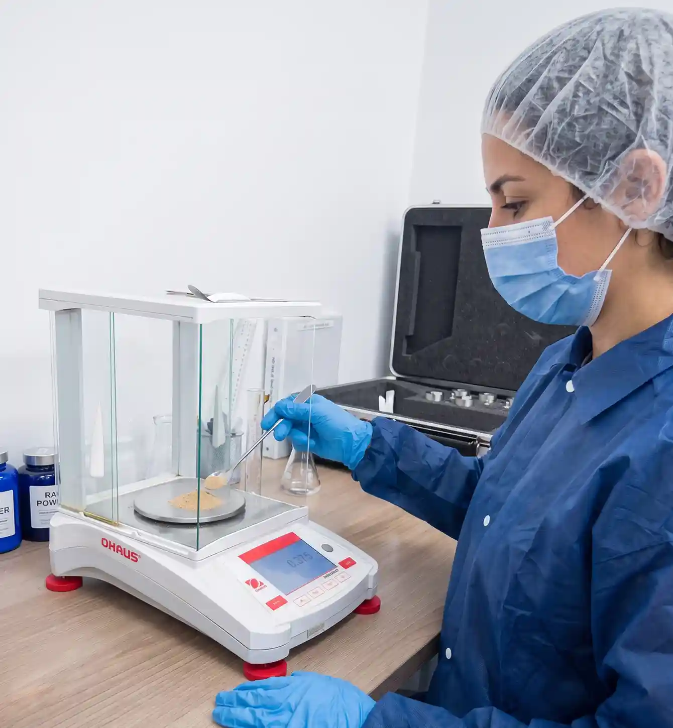 Technician weighing a sample on a digital balance