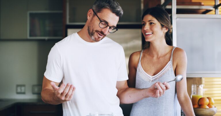 Happy couple preparing functional foods in the kitchen