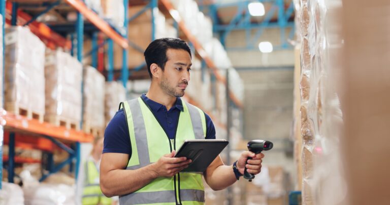 Warehouse worker scanning boxes of supplements