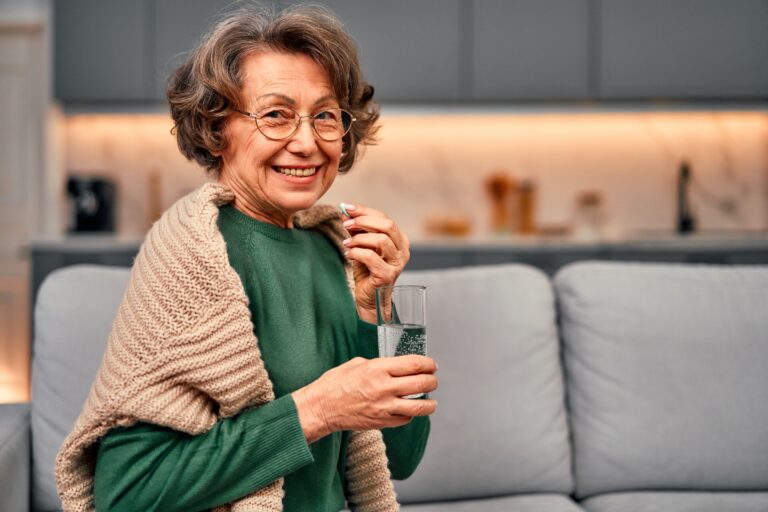 Senior woman taking supplements prescribed by her doctor