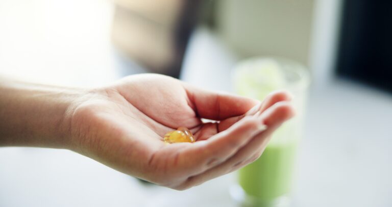 Hands holding supplement bottles demonstrating product distribution