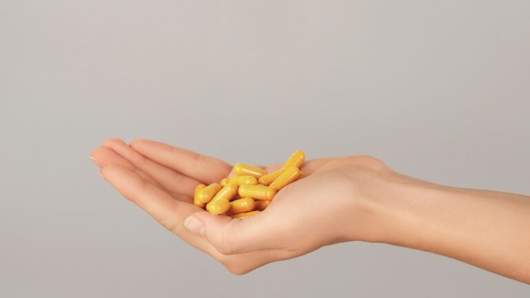 Health Genesis Curcumin capsules in hand