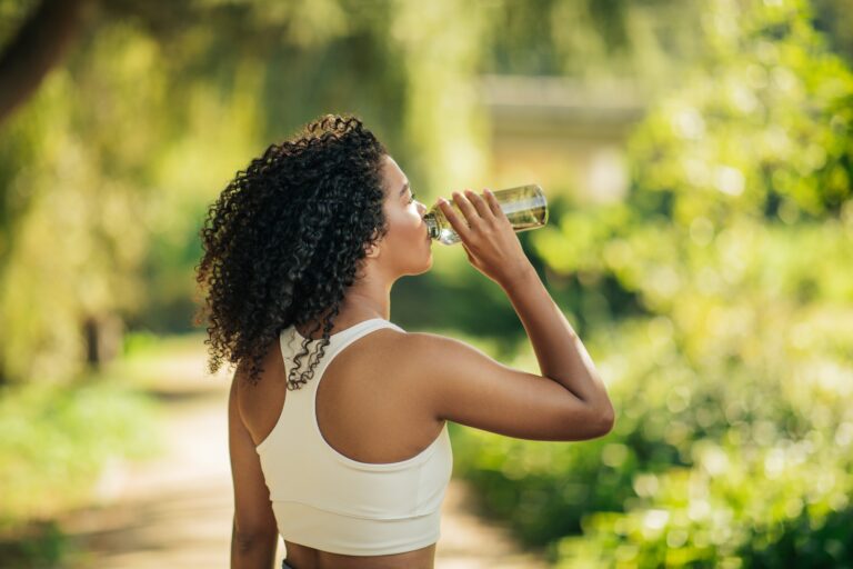 Woman drinking creatine while exercising