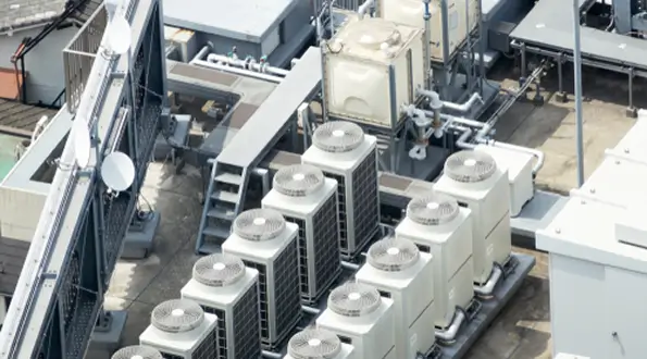 Rooftop HVAC condensing units and mechanical piping on a commercial building