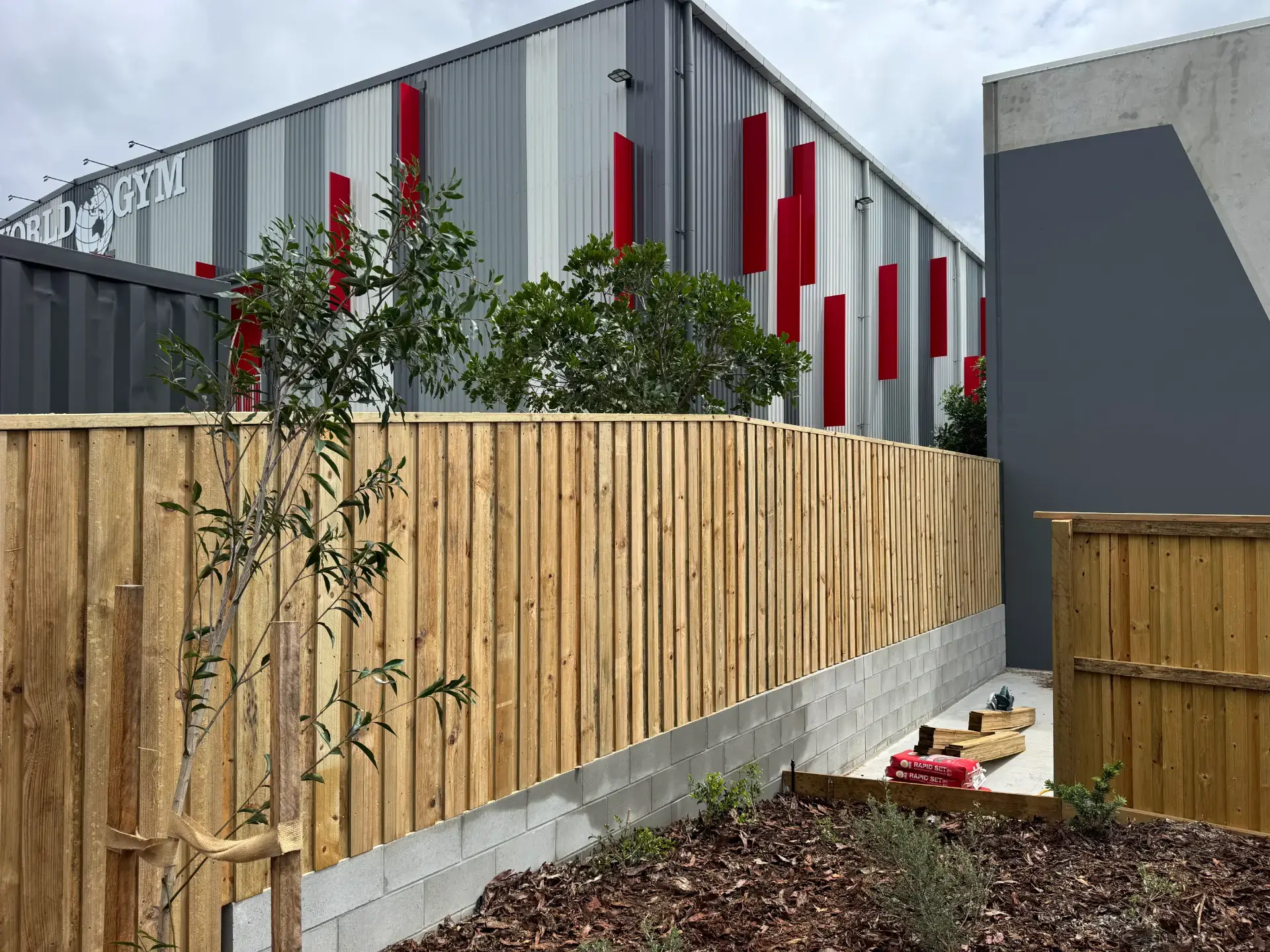 Timber paling fence on a besser-block base built by Synergy Fencing in Brisbane
