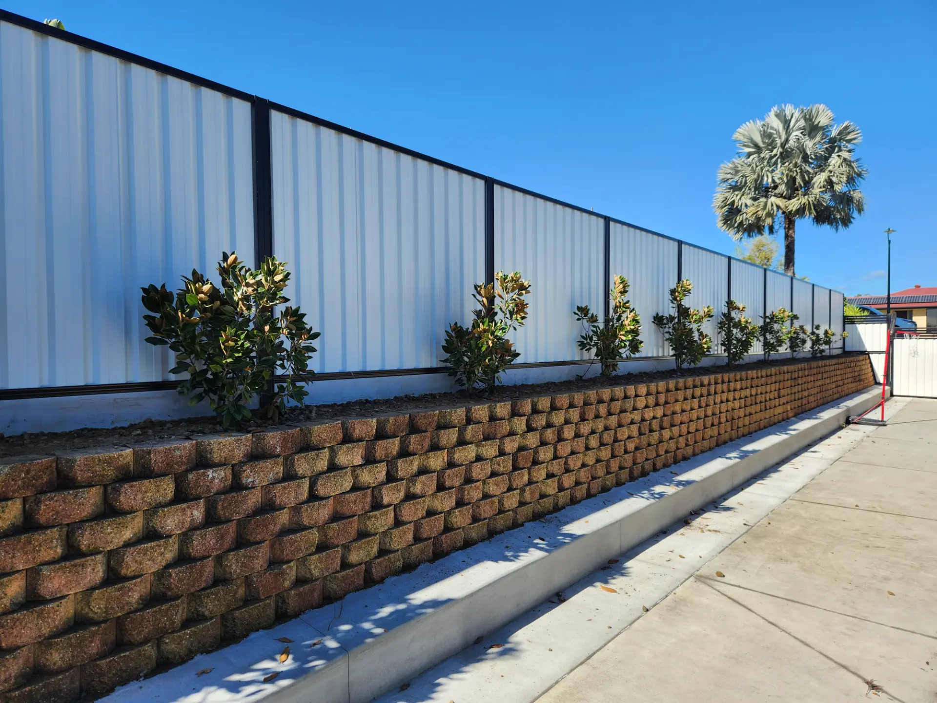 Colorbond fence on a block retaining wall built by Synergy Fencing in Brisbane