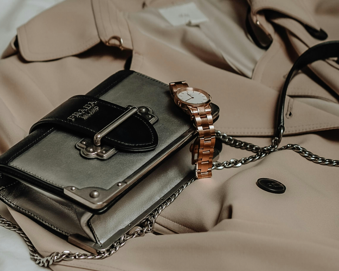 A Luxury 925 Italy chain next to a Prada designer bag