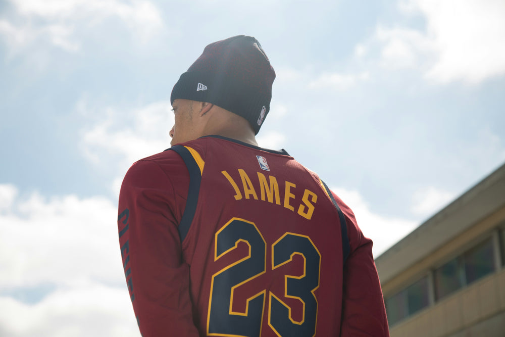 A man wearing a Lebron James jersey and jewelry