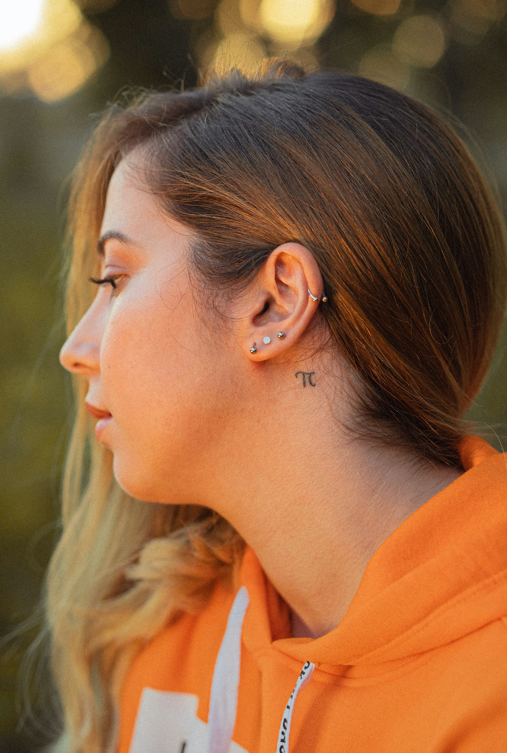 A woman wearing silver earrings