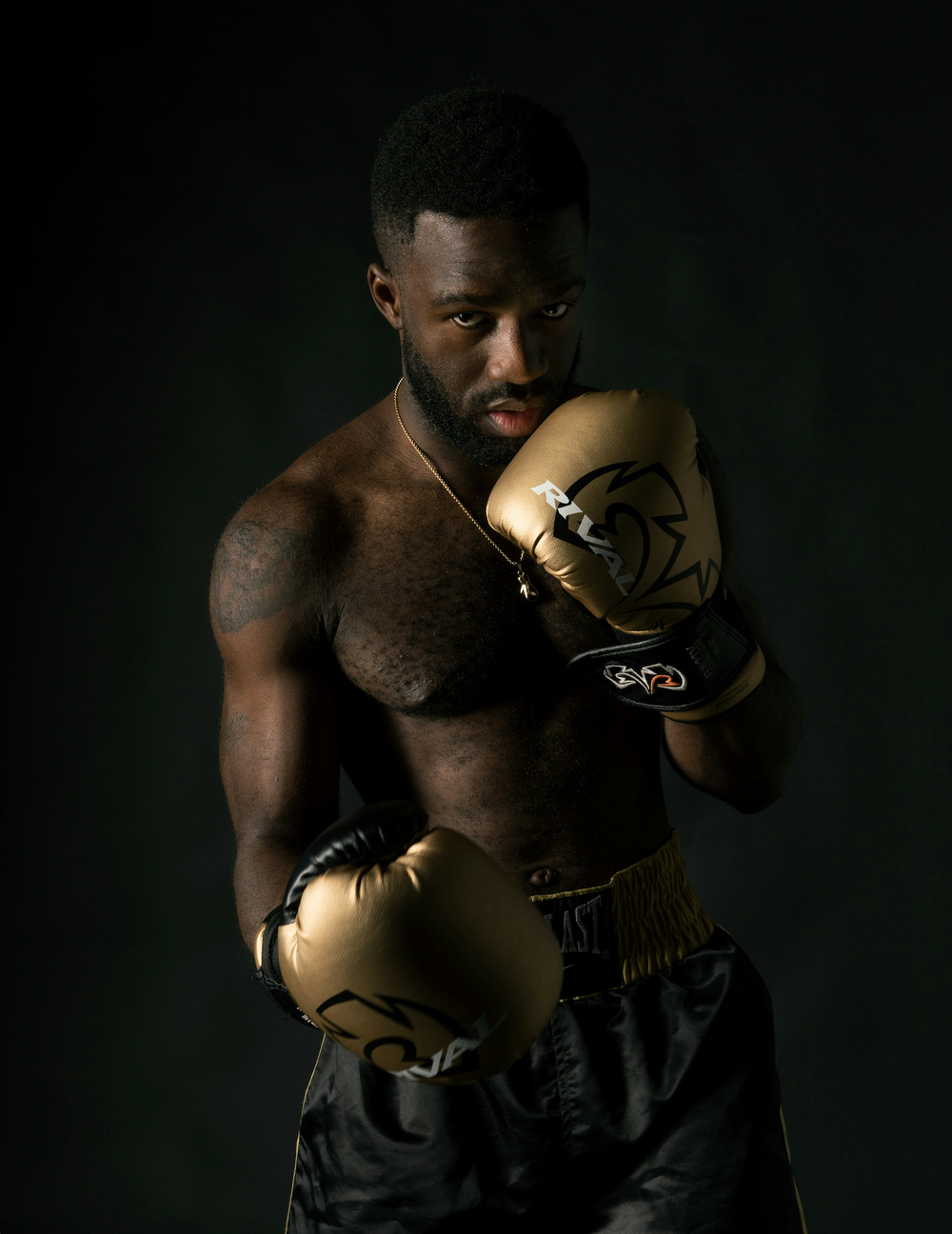 a man is boxing wearing jewelry