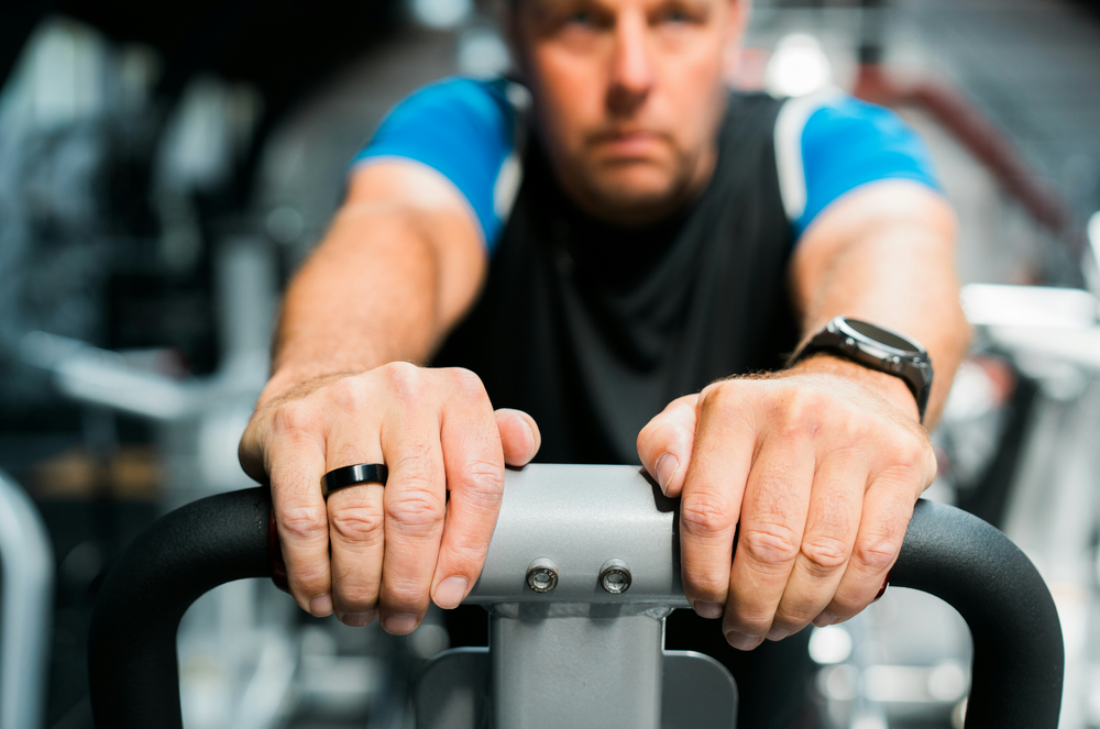 A man working out with silver jewelry