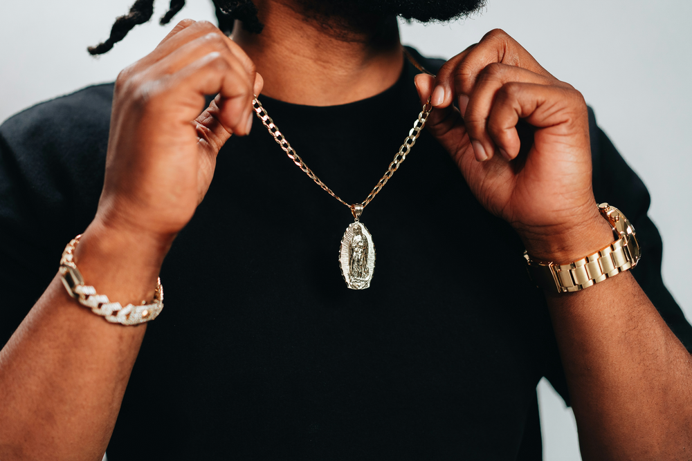 A man showing off a jewelry necklace