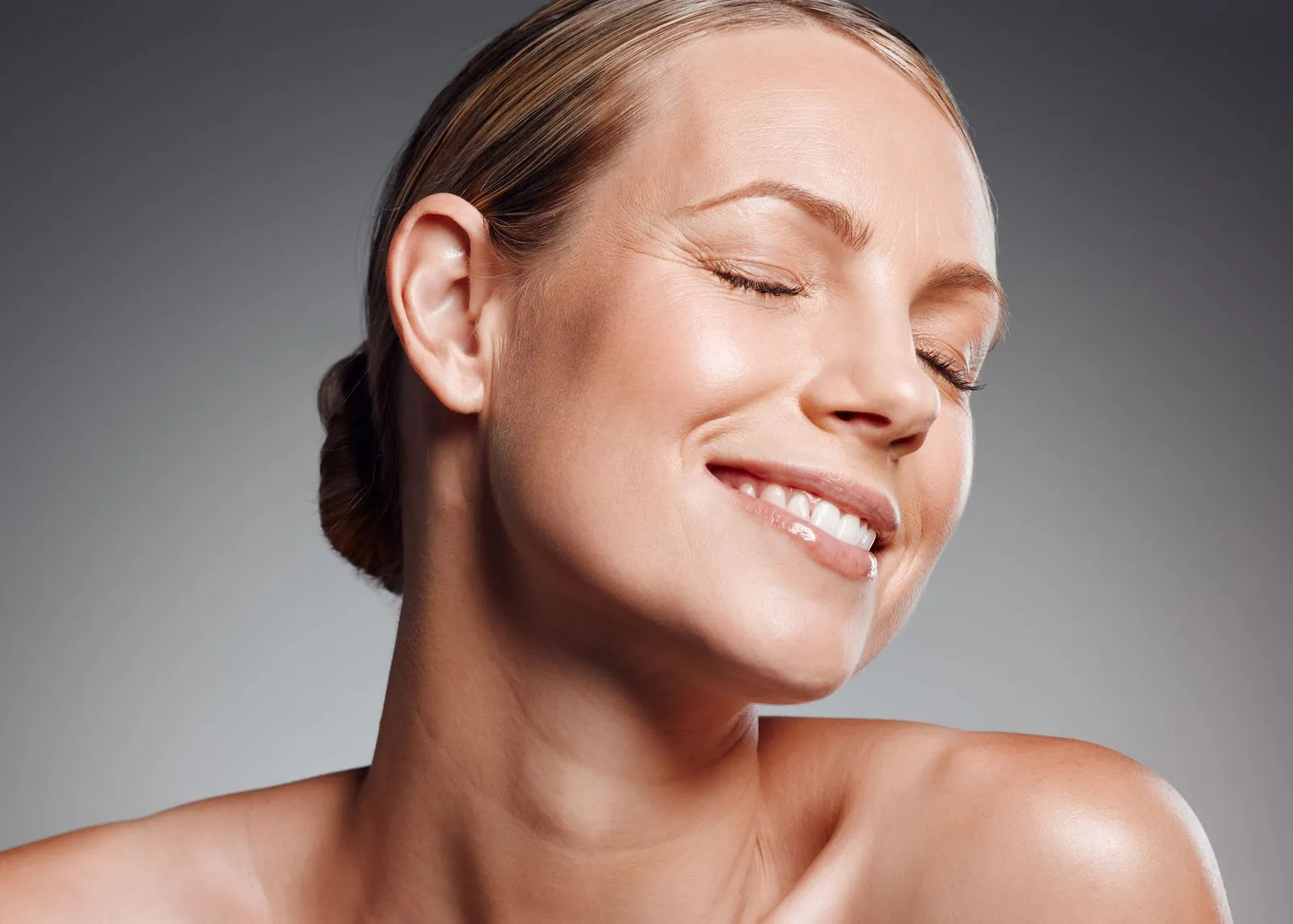 A woman with blonde hair smiling.