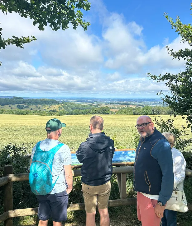 Tour guests enjoting the panoramic views from the view point at Cotswold Lavender. The view pan from Birmingh on the horizon to the Shropshire Hills, the Malvern Hills and the Black Mountains just over the Welsh border.