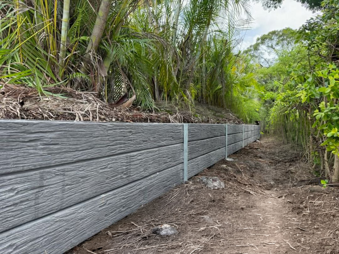 Large concrete sleeper retaining wall built by Synergy Fencing on a residential Brisbane property