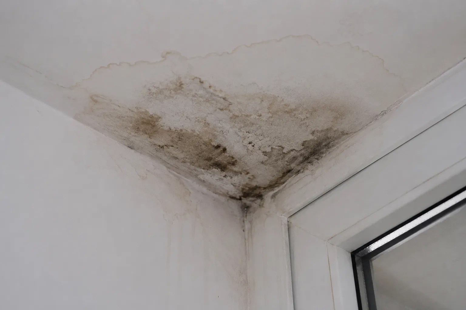 Water ingress damage visible on building facade