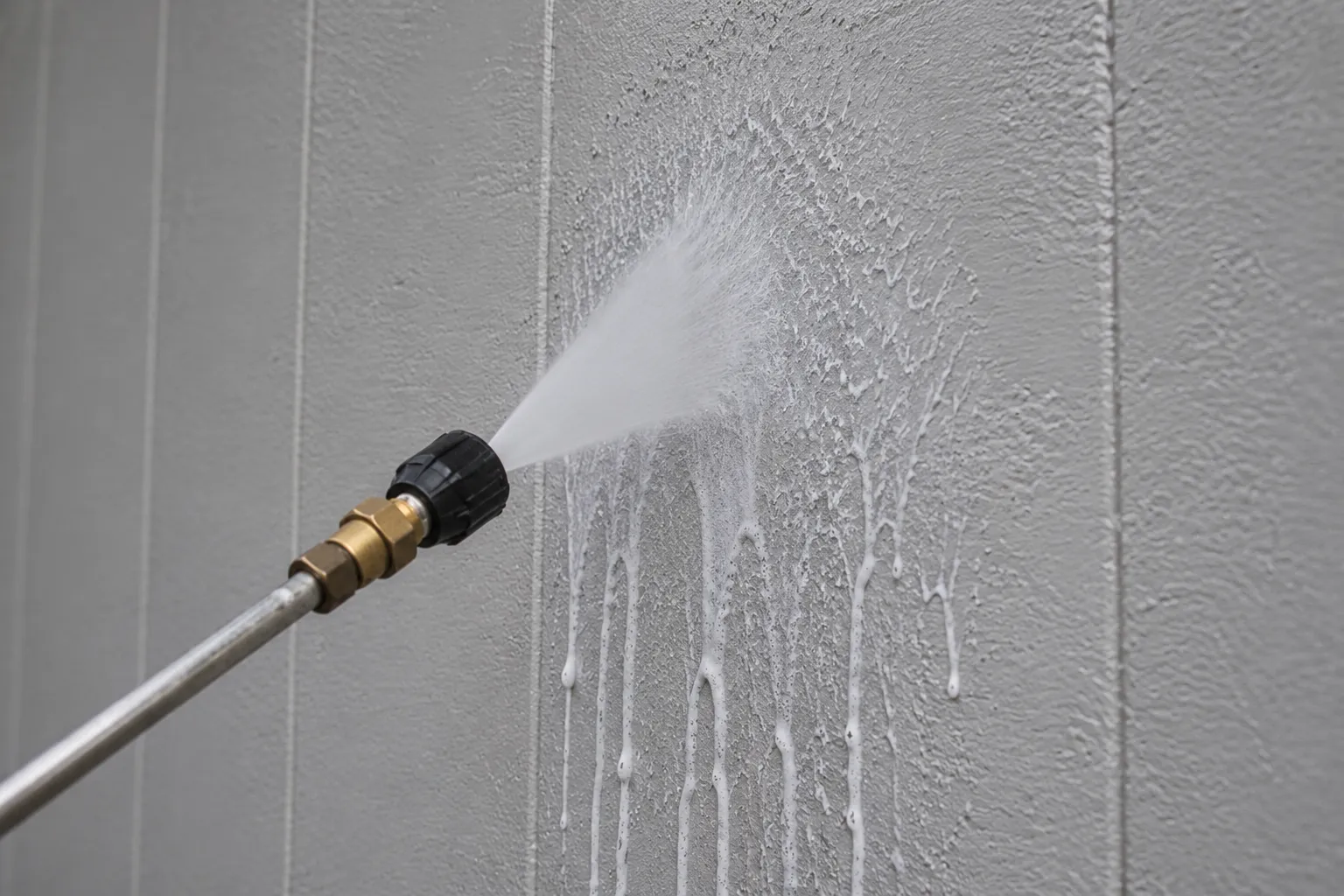 Building maintenance worker cleaning facade