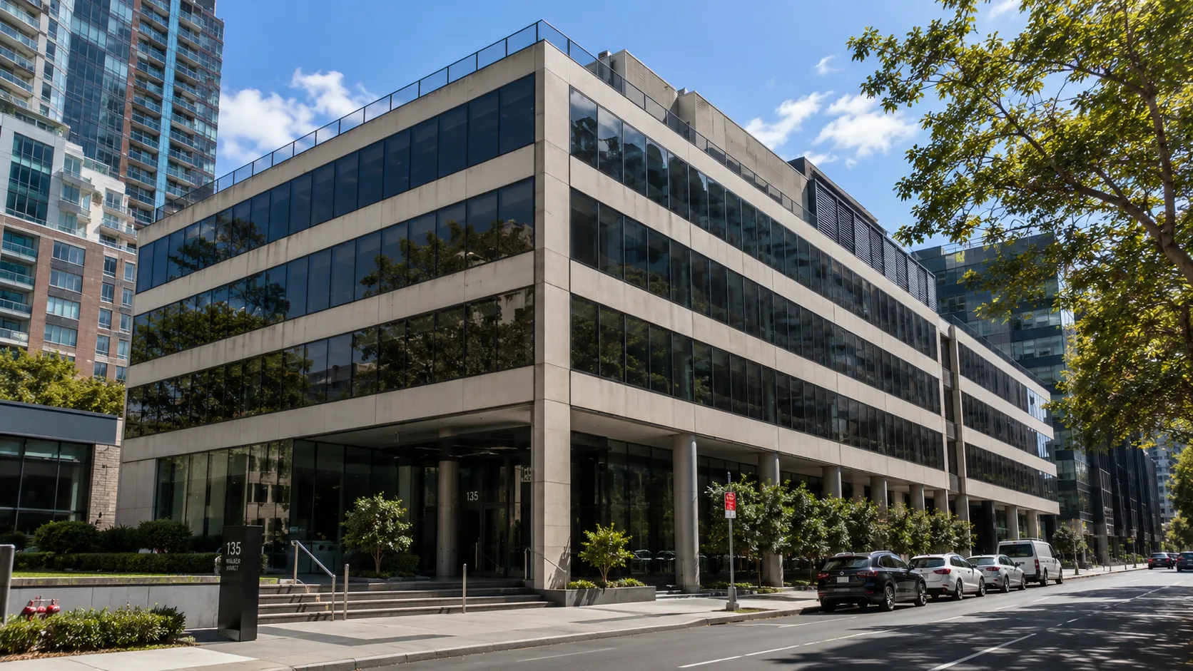 Multi-storey glass-and-concrete commercial office building on a city street