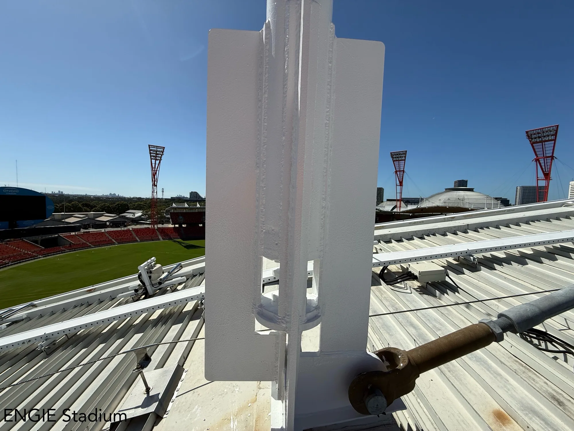 Rooftop steel mast base cleaned, primed and repainted after remedial protective coating