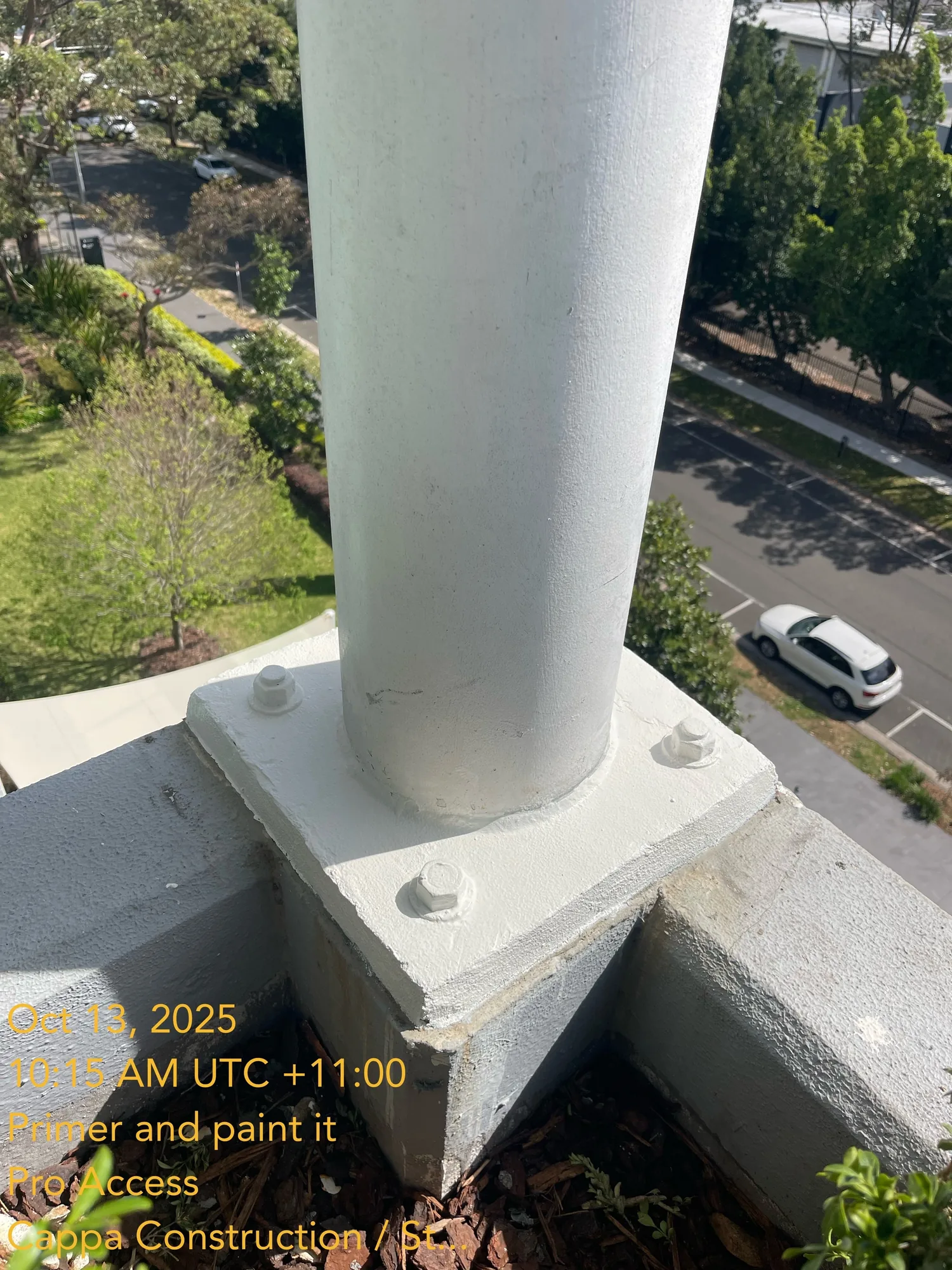 Steel column baseplate primed and painted white after rope-access remedial coating, Sydney