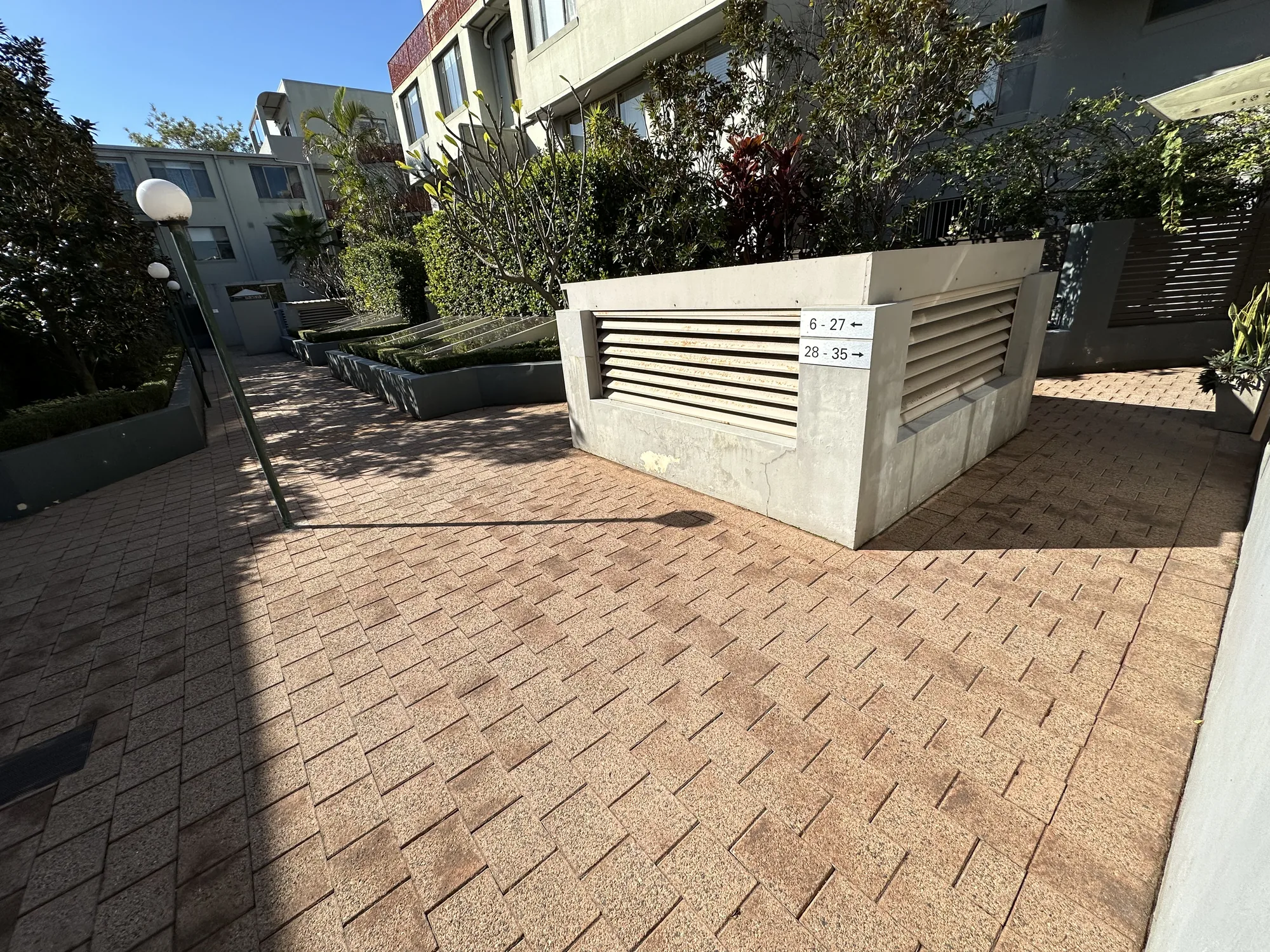 Strata courtyard pavers cleaned of moss and grime after pressure washing and re-sanding, Sydney