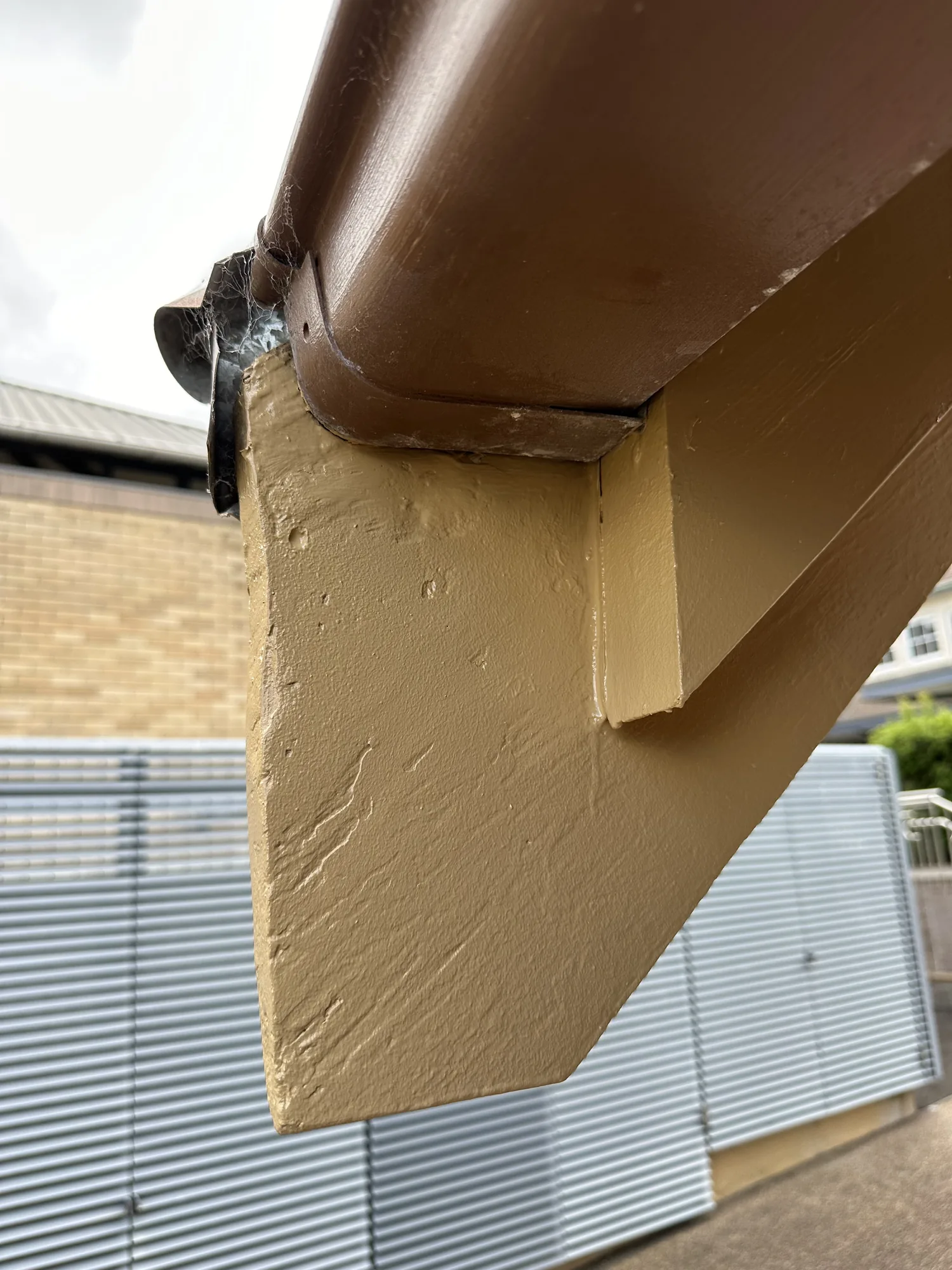 Timber fascia and barge board filled and repainted in tan after remedial carpentry