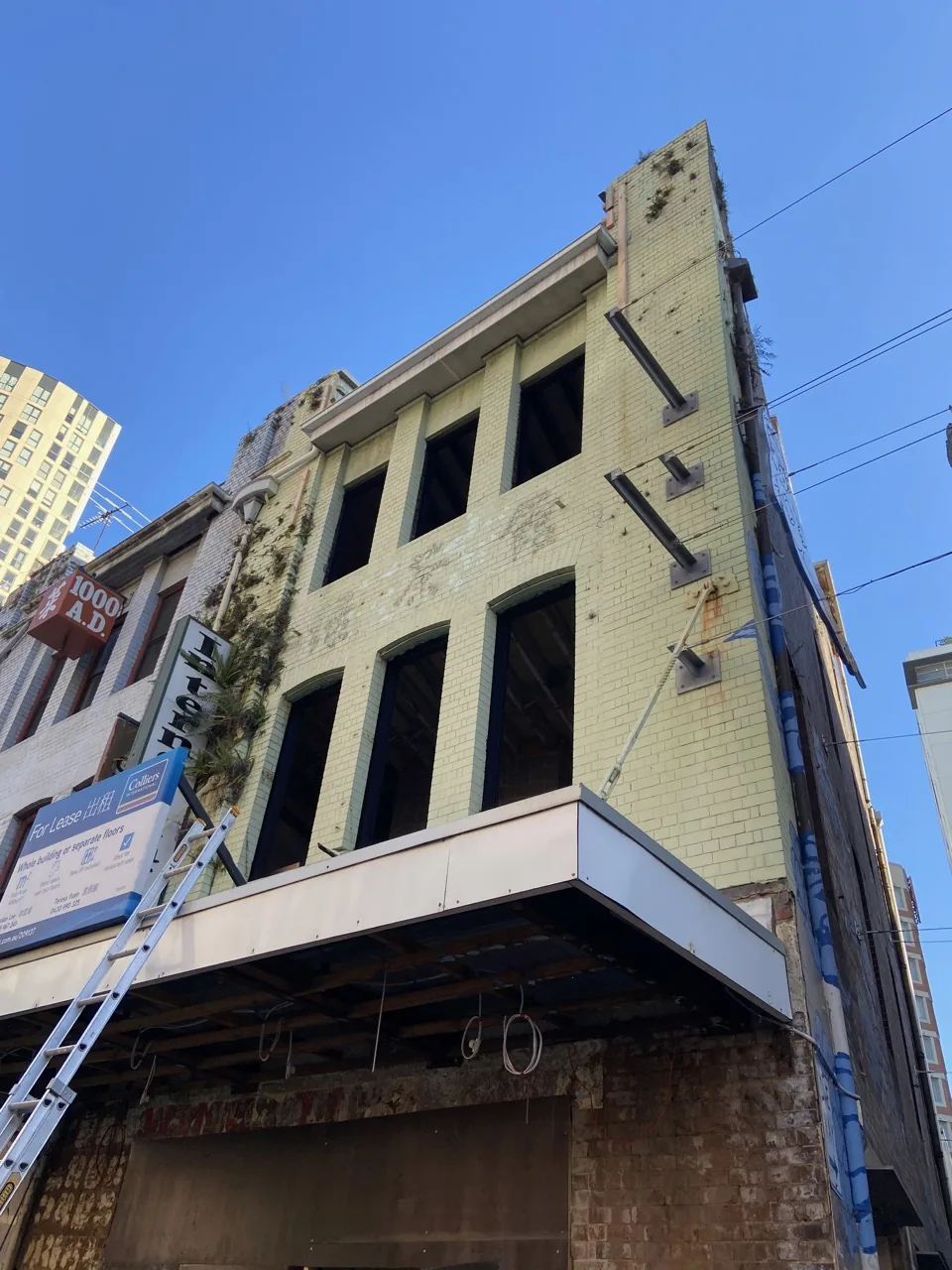 Weathered heritage CBD facade with organic growth before facade restoration, Sydney