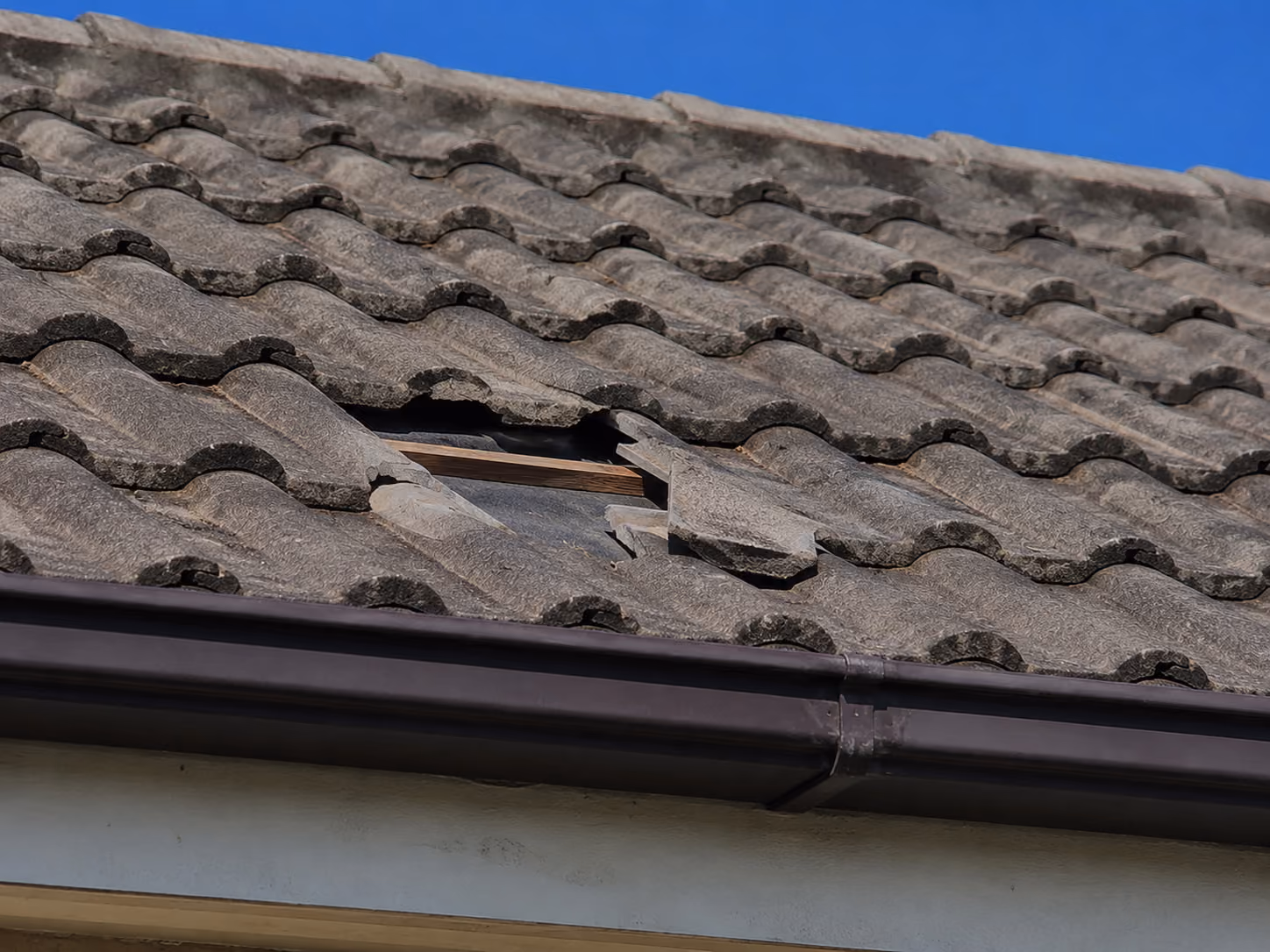 Concrete tiled roof with a missing and broken tile