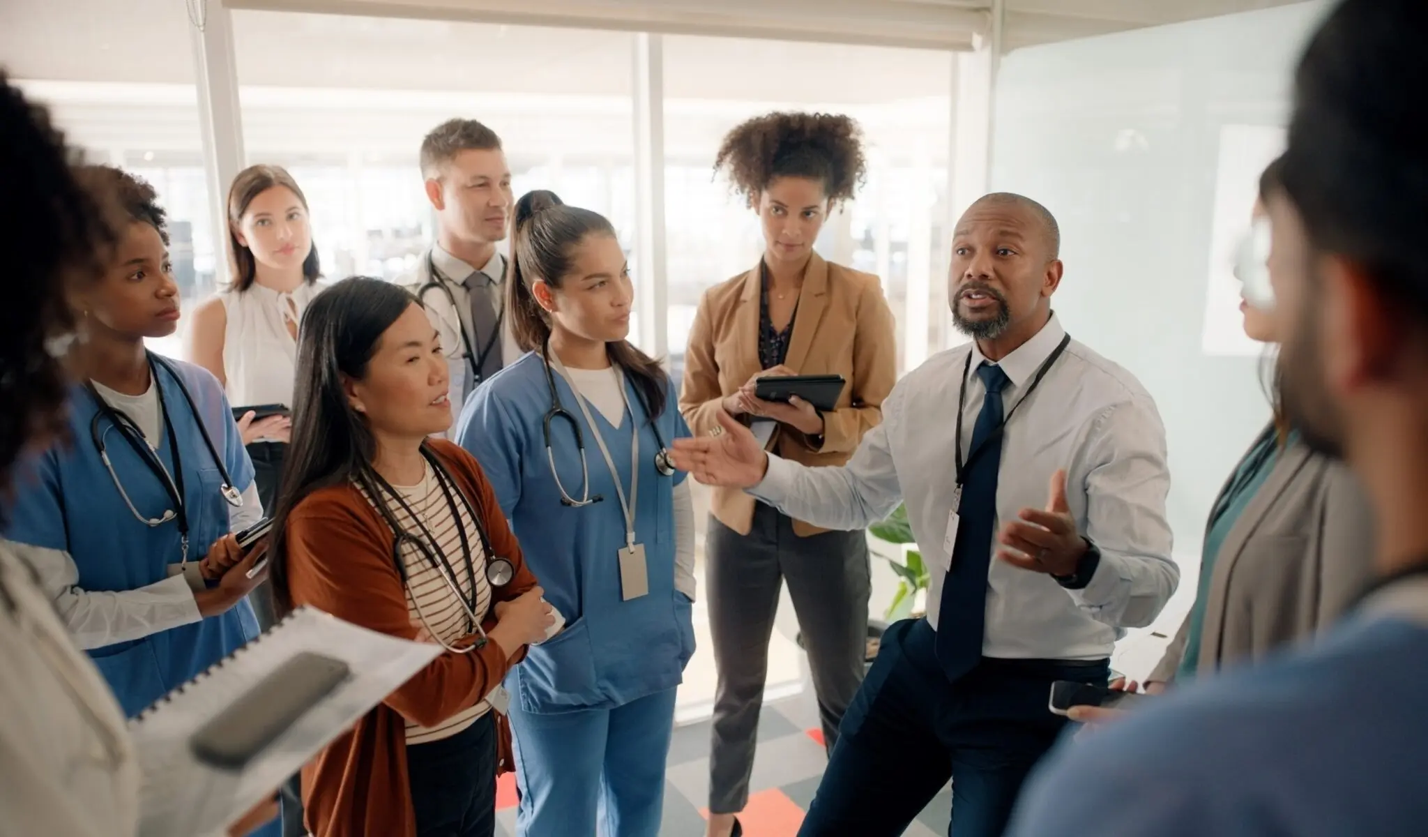 Physician leading a discussion with clinical staff